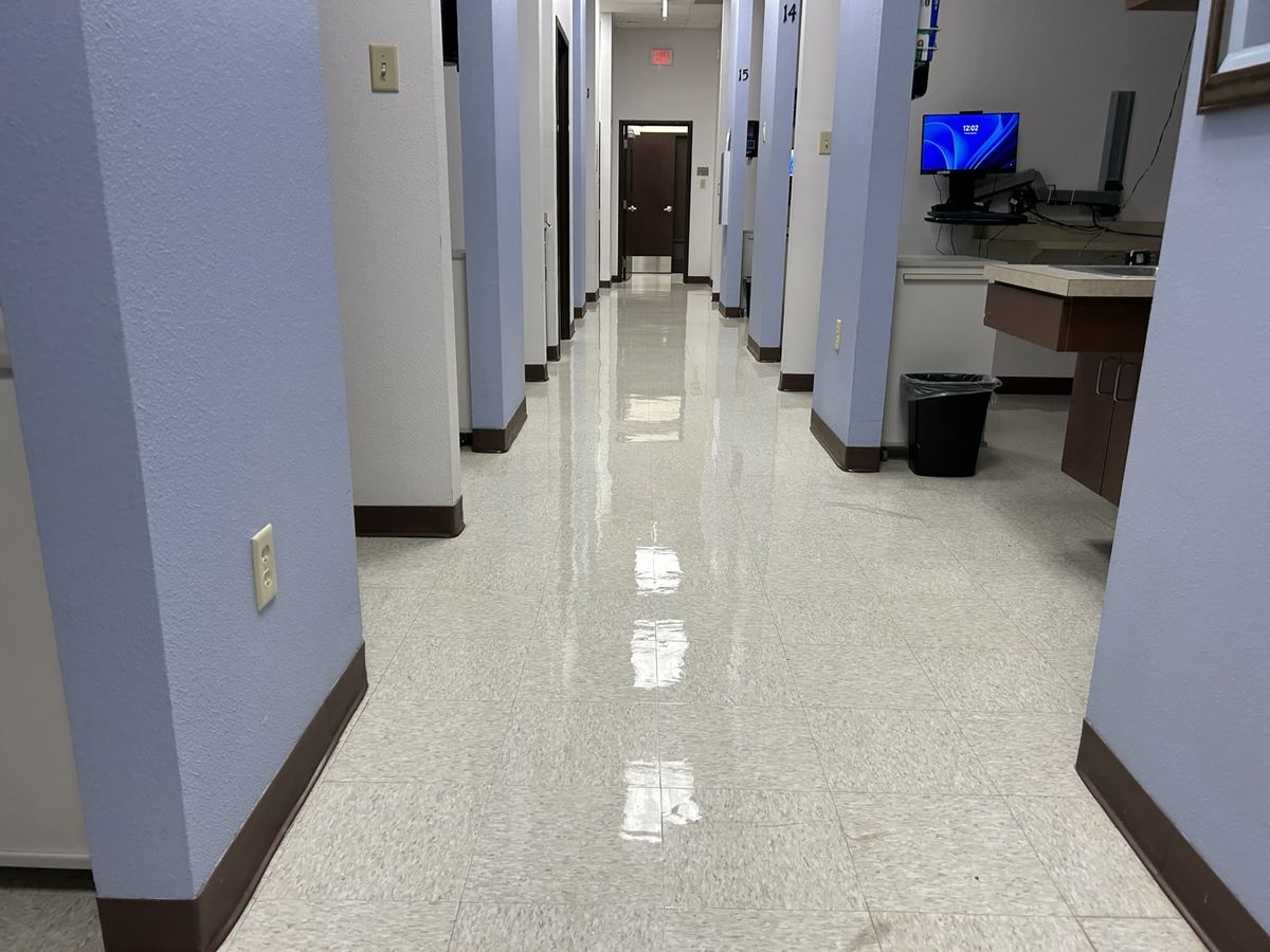 Long clean hallway with reflective floor finish